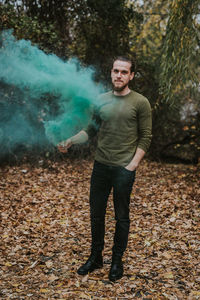 Portrait of young man standing on land