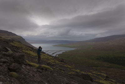 Man standing on mountain against sky