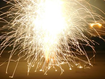 Low angle view of firework display at night