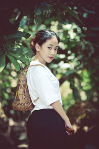 Portrait of young woman standing outdoors