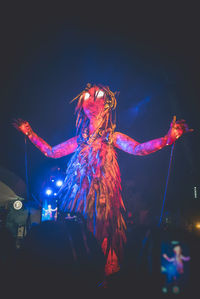 Low angle view of illuminated lighting equipment at night