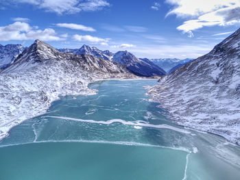 Scenic view of sea and mountains against sky