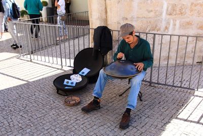 Man sitting on footpath