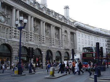 People walking in front of historical building