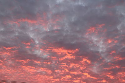 Low angle view of cloudy sky at sunset