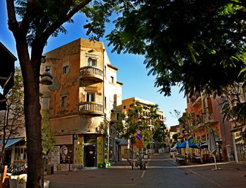 Street amidst buildings against sky