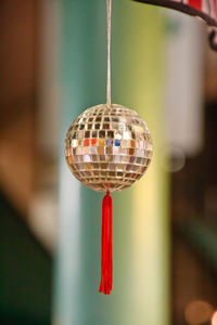 Close-up of christmas decoration hanging against wall