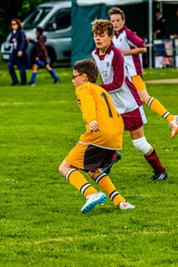 Full length of boys on soccer field