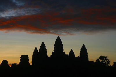 Low angle view of silhouette trees against sky at sunset