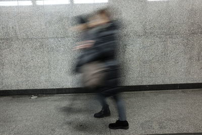 Blurred motion of people walking in basement