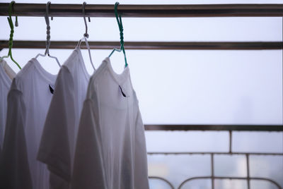Close-up of clothes drying on clothesline against wall