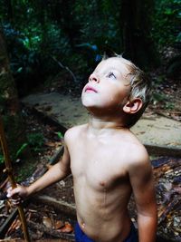 Boy looking away in forest