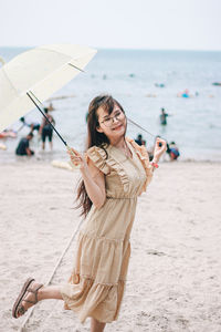 Young woman using mobile phone at beach