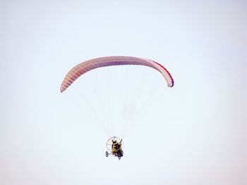 Low angle view of powered paragliding against sky