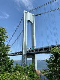 Low angle view of suspension bridge against sky