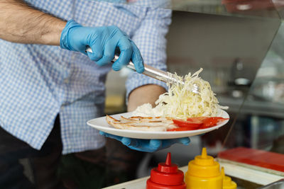 Midsection of man preparing food