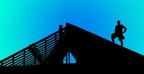 Silhouette of a worker against sky