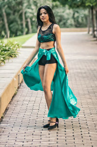Portrait of smiling young woman walking outdoors