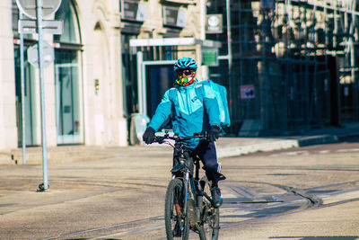 Man riding bicycle on street