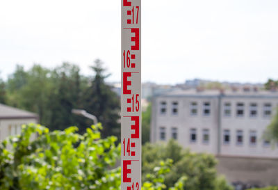 Close-up of information sign against trees