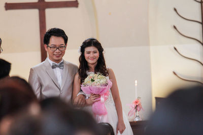 Bride and bridegroom standing at church during wedding ceremony