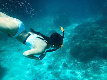 High angle view of woman swimming underwater in sea