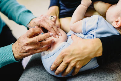 Midsection of couple holding hands