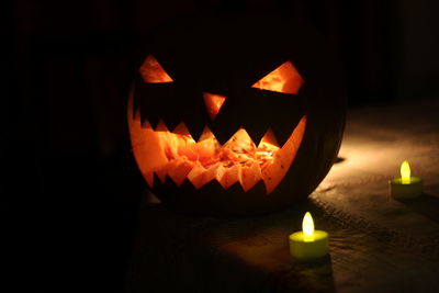 Close-up of illuminated pumpkin against black background