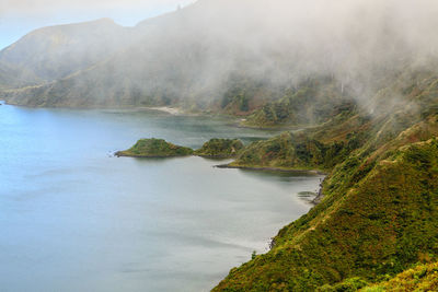 Scenic view of lake and mountains against sky