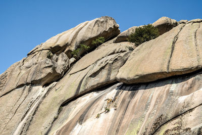 Low angle view of rock formation against clear sky