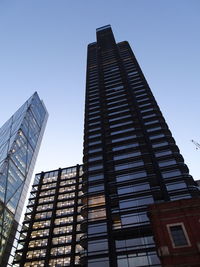 Low angle view of modern buildings against clear sky