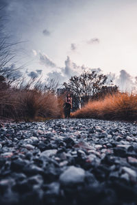 Surface level of person standing on land against sky