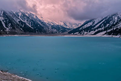 Scenic view of lake against sky during winter