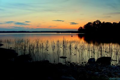 Scenic view of lake against sky during sunset