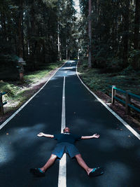 High angle view of woman walking on road