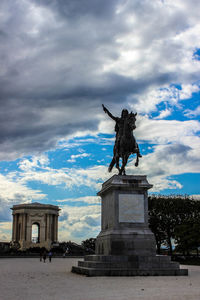 Low angle view of statue against cloudy sky