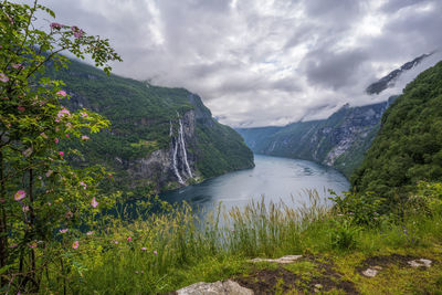 Scenic view of river amidst mountains against sky