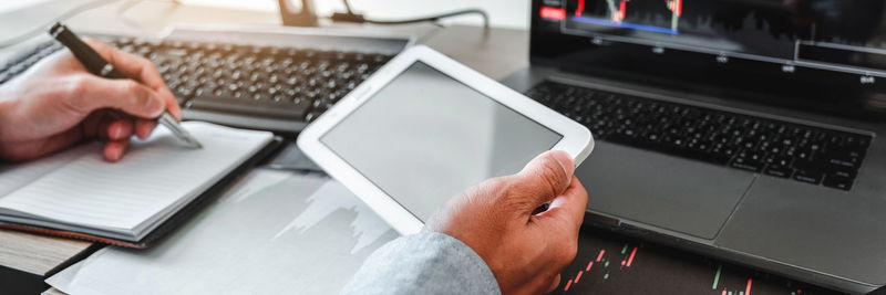 Cropped hand using laptop