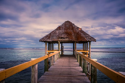 Pier over sea against sky