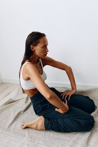 Young woman sitting on floor