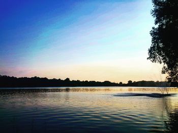 Scenic view of calm lake at sunset