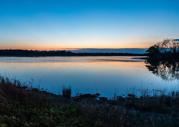 Scenic view of lake against sky during sunset