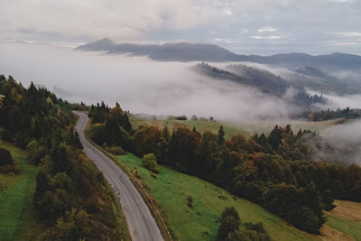 Beautiful misty foggy morning in mountains with fog on the hills. early autumn. aerial drone view