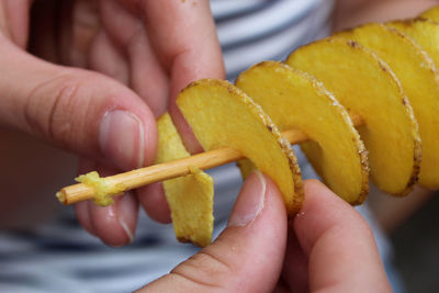 Close-up of person holding yellow food