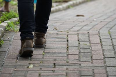 Low section of man walking on footpath