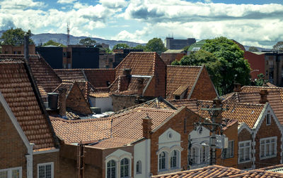 High angle view of houses against cloudy sky