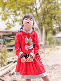 Portrait of cute girl standing outdoors