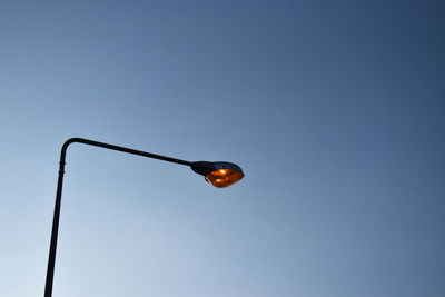 Low angle view of street light against sky