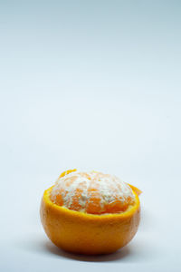 Close-up of orange slice against white background