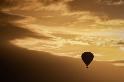 Low angle view of hot air balloon against sky during sunset